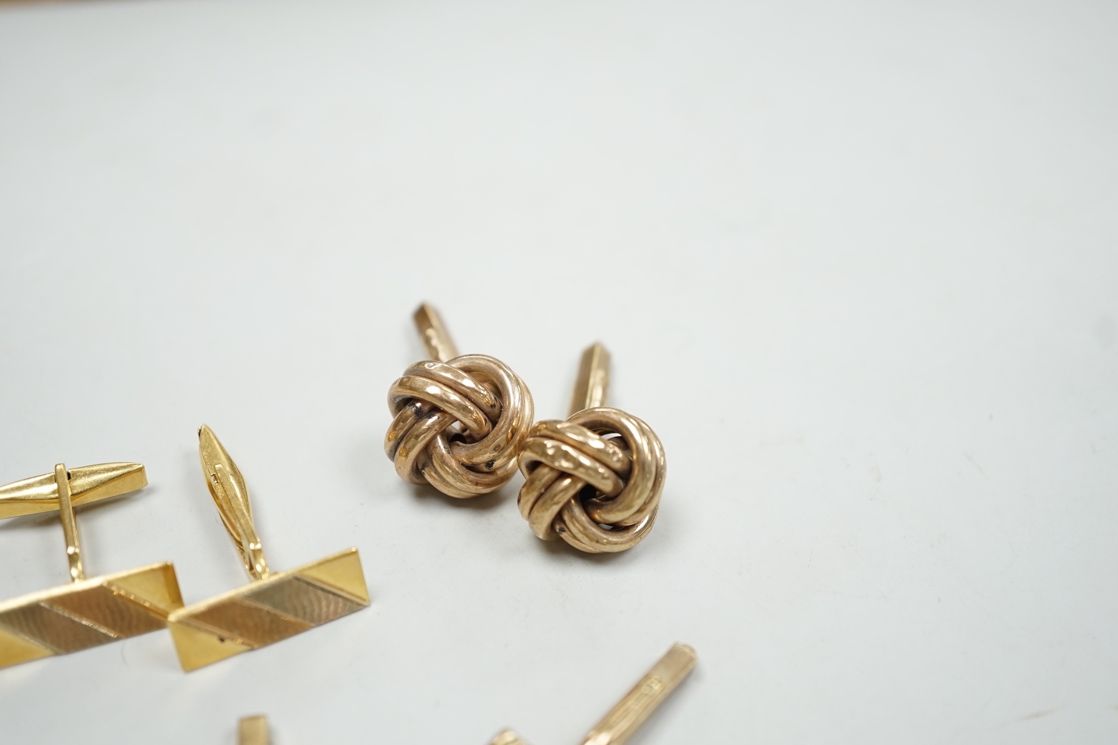 A modern three colour 750 pair of cufflinks, 9.2 grams, a pair of 9ct gold oval cufflinks one other 9ct gold pair and two odd 9ct gold cufflinks, 20.7 grams.